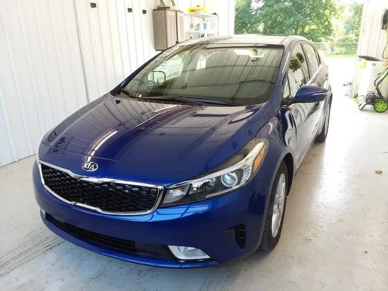 Blue Kia Forte after its front-end repair at Spanky's Collision Repair